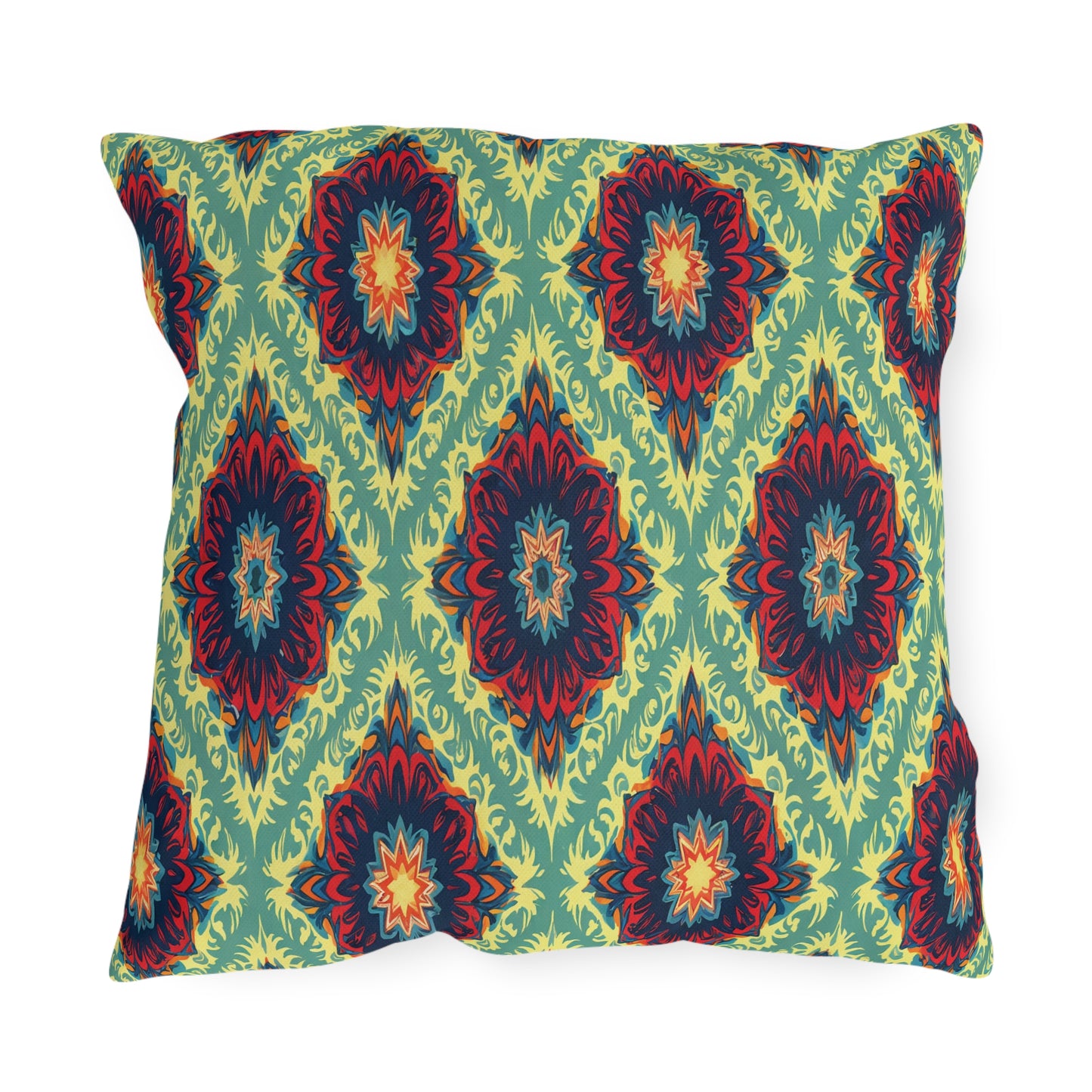 Square pillow with a green background features a symmetrical, bold African-inspired ikat pattern in red, yellow, dark blue, and orange. The design forms diamond shapes with intricate, layered, floral-like centers evenly spaced across the pillow’s surface.