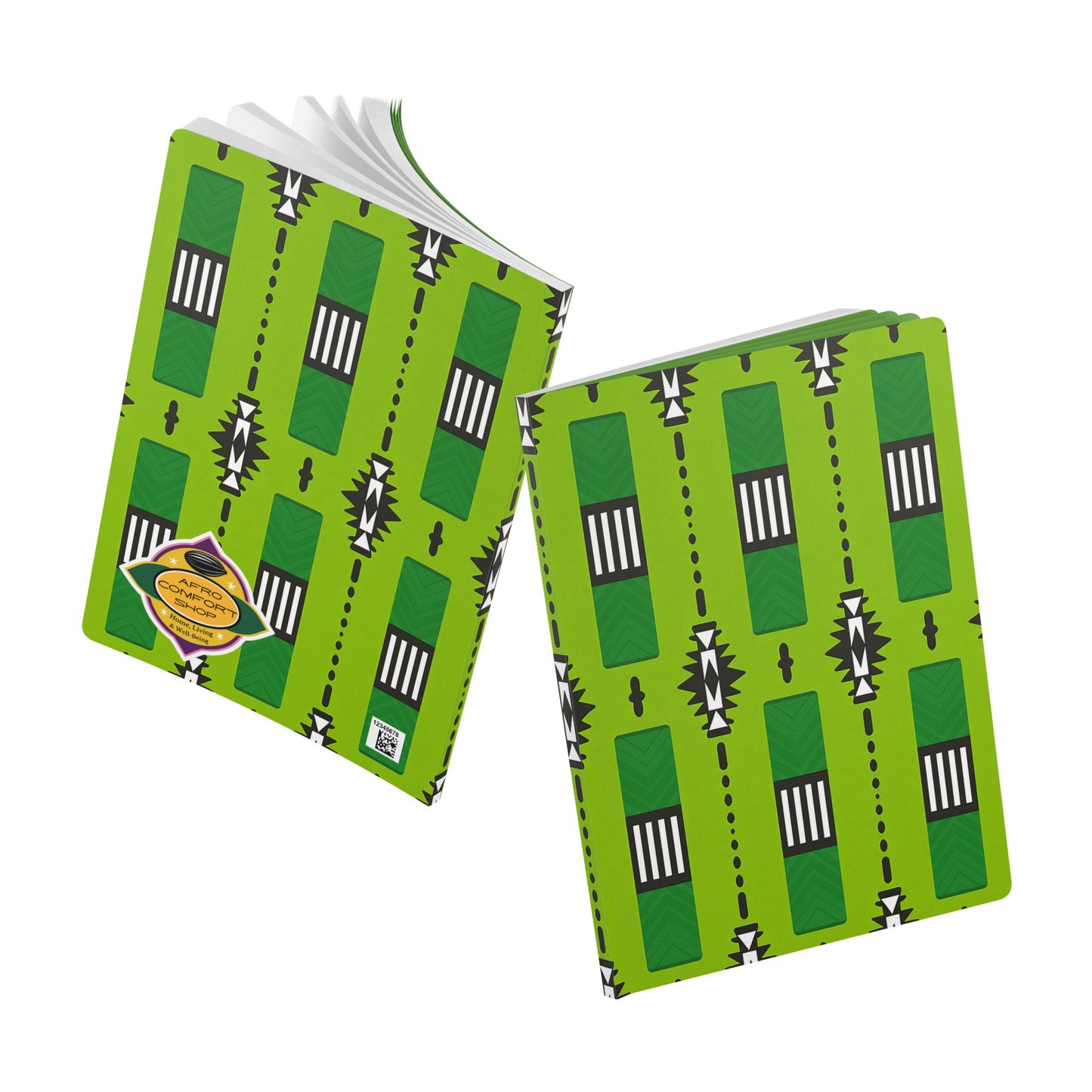 Two green African-inspired journals feature geometric black and white patterns on the covers. One creative journal is open, displaying white pages, while the other is closed with a yellow and black label. Both rest on a white background.