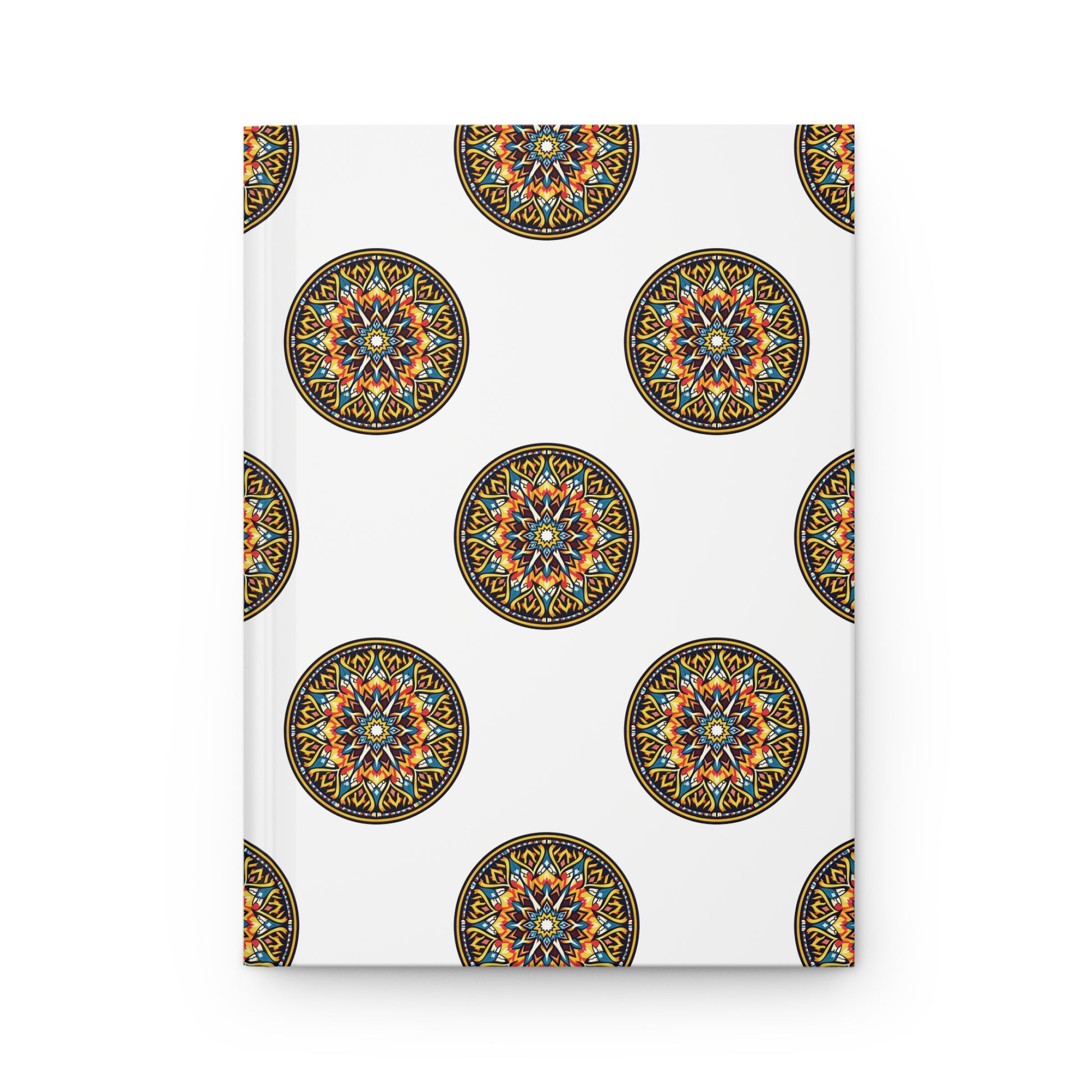 A white hardcover journal featuring a repeating pattern of colorful, African-inspired mandalas. Intricate geometric designs in yellow, orange, blue, and black decorate the cover. Includes lined pages for organized note-taking.