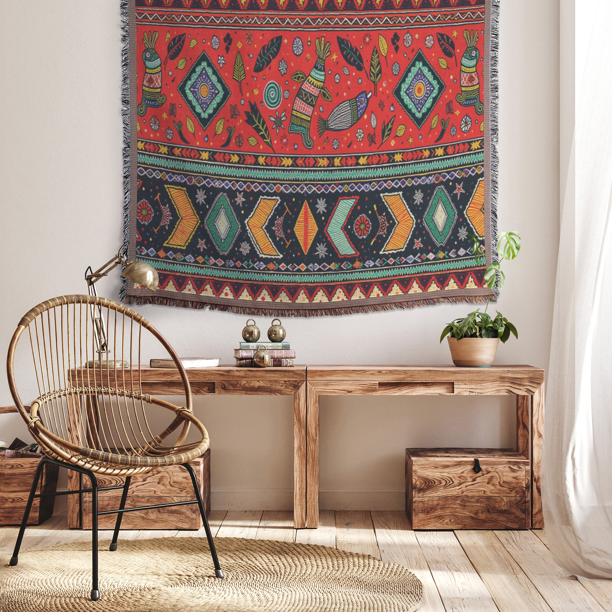 A cozy room with a wooden floor features a rattan chair, rustic wooden bench with books and a potted plant, and an African-inspired, colorful tapestry with animal and diamond motifs hanging on the white wall above. Soft light streams in from the right.