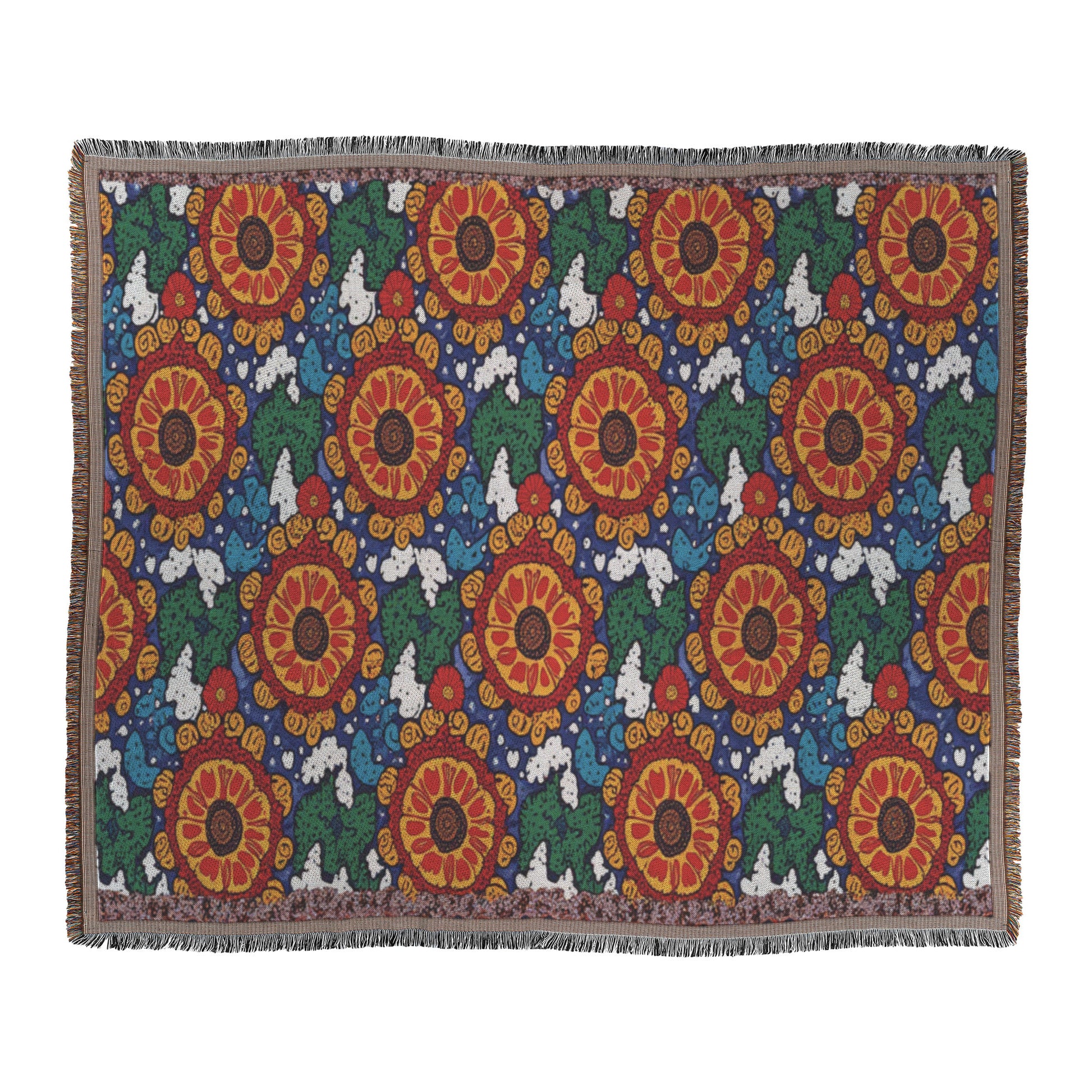 An African-inspired rectangular woven blanket with large red and orange flower patterns, green leaves, and white cloud-like shapes on a dark blue background. The blanket features fringed edges and a repeated, symmetrical floral design.