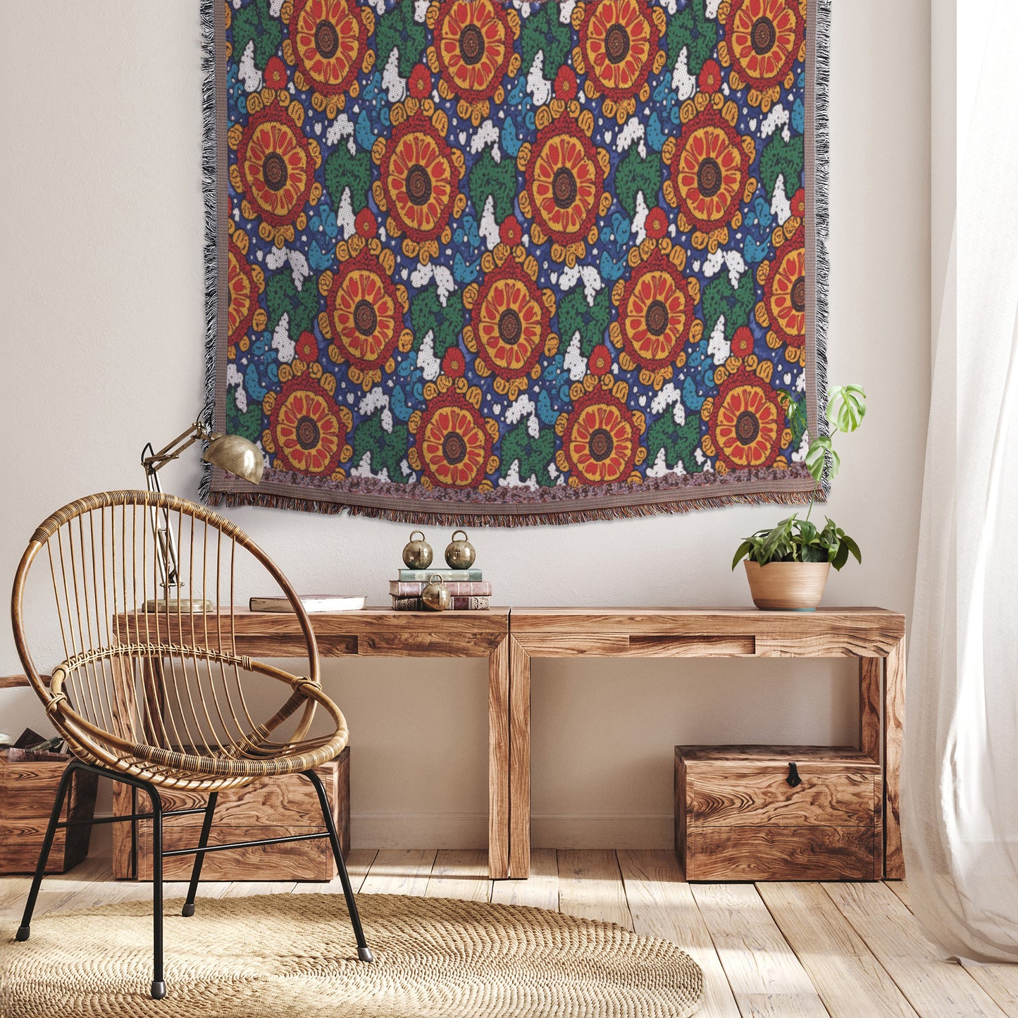 A cozy, African-inspired room with a wicker chair, a rustic wooden bench filled with books and a potted plant, and a colorful floral tapestry on the wall. Sunlight filters through sheer curtains onto wooden floors and two wooden storage boxes under the bench.
