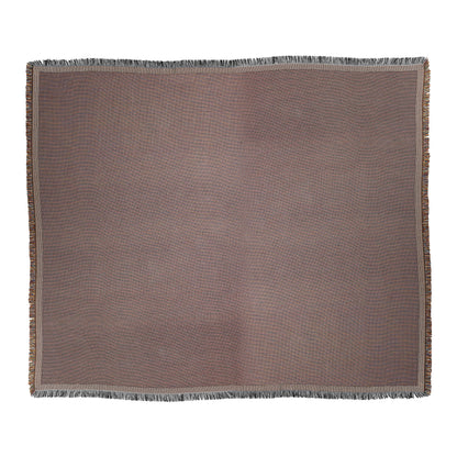 A rectangular brown woven blanket with subtle texture and African-inspired design, featuring a fringe along all four edges. The color appears uniform with slight shading variations, and the blanket is laid flat against a white background.