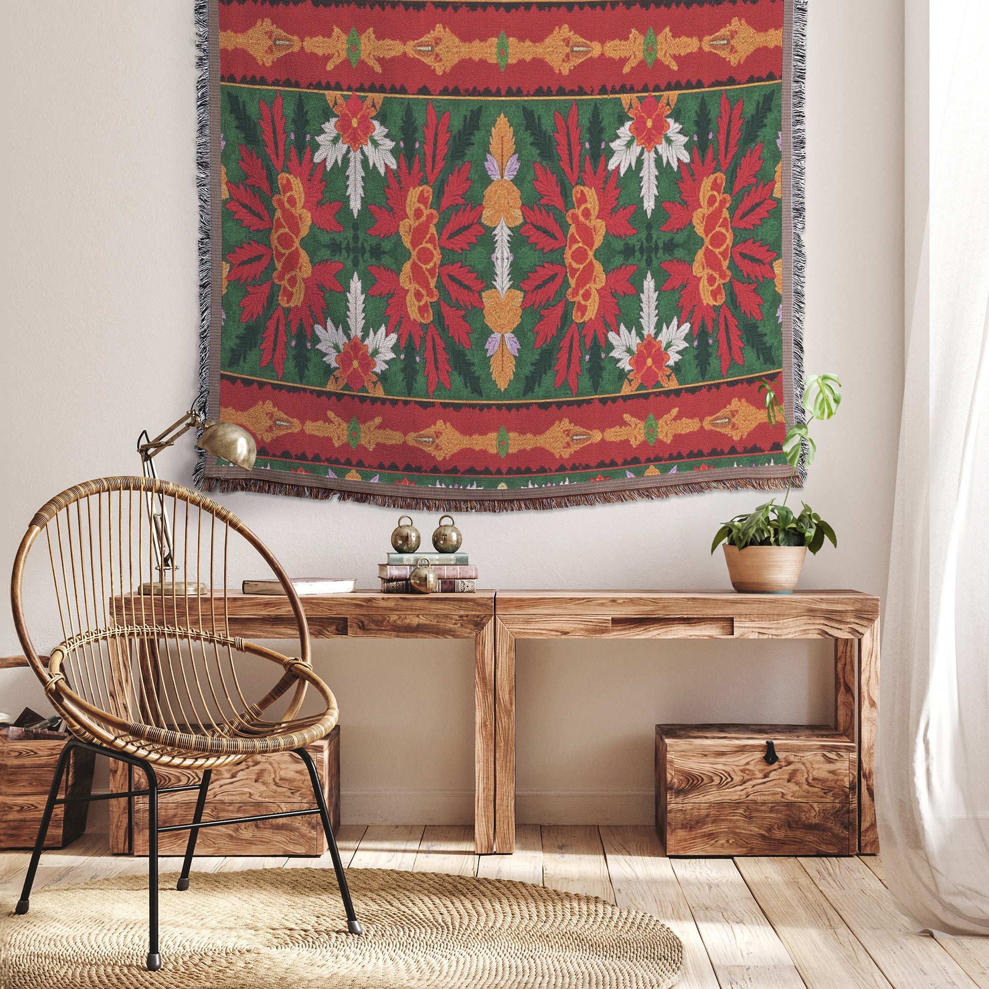 A cozy, African-inspired room with light wood floors, a rattan chair with black metal legs, a low wooden bench, a potted plant, books, and a brass desk lamp. A colorful tapestry with red, green, yellow, and white floral patterns hangs on the wall. Sunlight streams in.