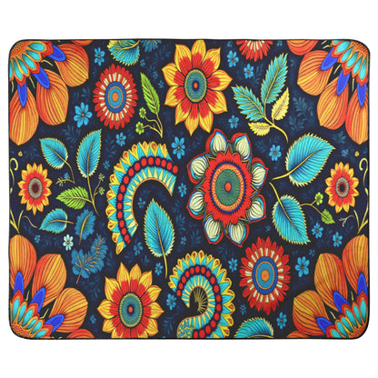 A rectangular mat with a vibrant floral pattern and African-inspired patterns. Large orange, red, and yellow flowers with blue-green leaves are set against navy, creating a colorful, symmetrical, and ornate look.